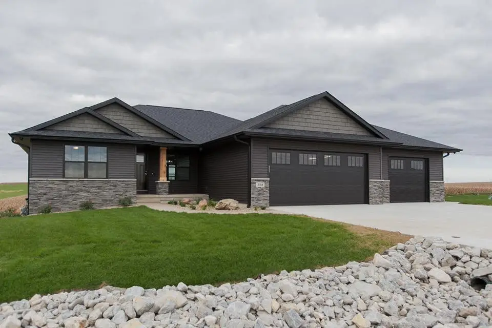 Custom home build in Palo Iowa with dark siding and stone accents